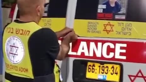 Thumbnail for Magen David Adom ambulance crew take off the pictures of some of the already released Israeli hostages